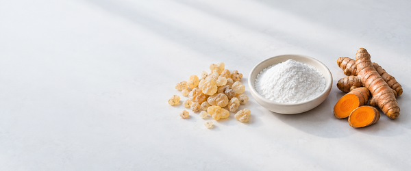 Editorial ingredient illustration of Boswellia resin, MSM powder and turmeric on a light background.